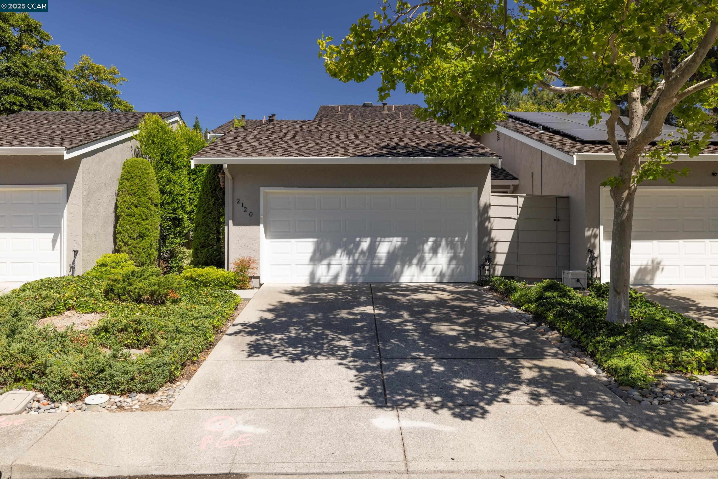 a front view of a house with garden