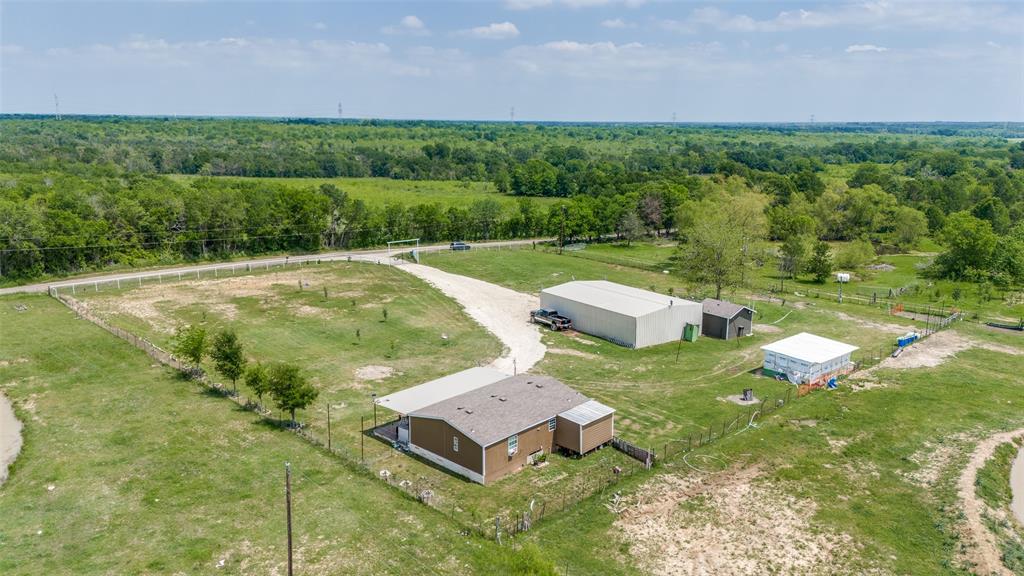 View of rural area with a heavily wooded area and agricultural land
