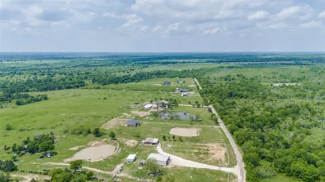 a view of a big yard with lots of green space
