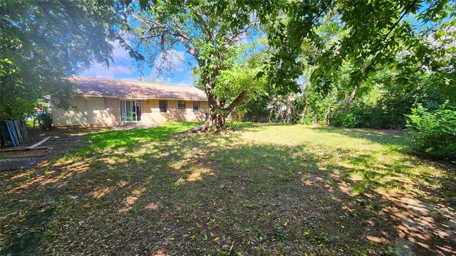 a view of outdoor space with garden and trees