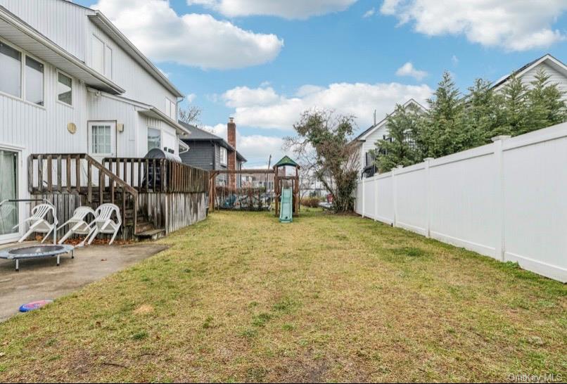 575 Rica Lane Woodmere, NY 11598 - Photo 17 of 24 Fenced backyard with a playground