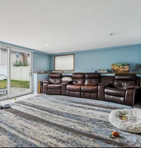 a living room with furniture cabinets and window