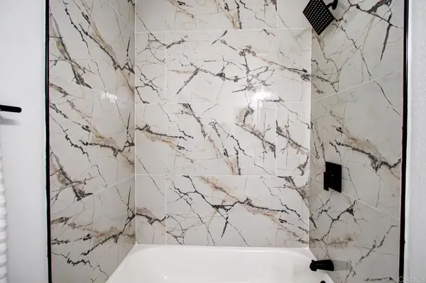a bathroom with a bathtub and shower