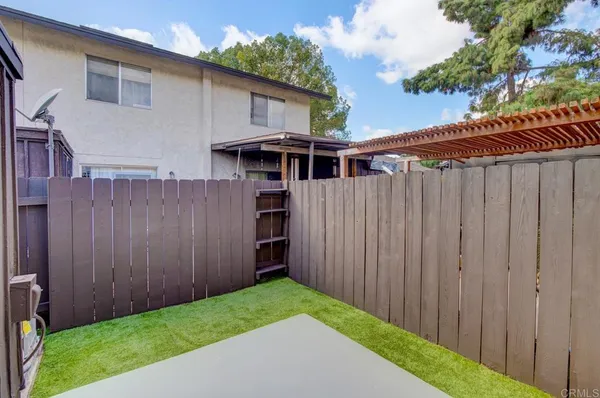 a backyard of a house with wooden fence