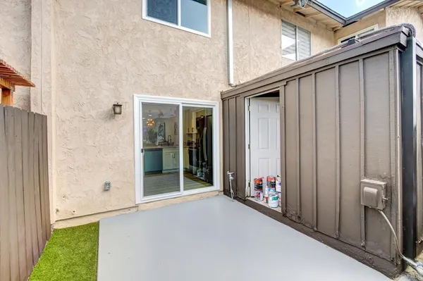 a backyard of a house with wooden floor and entryway