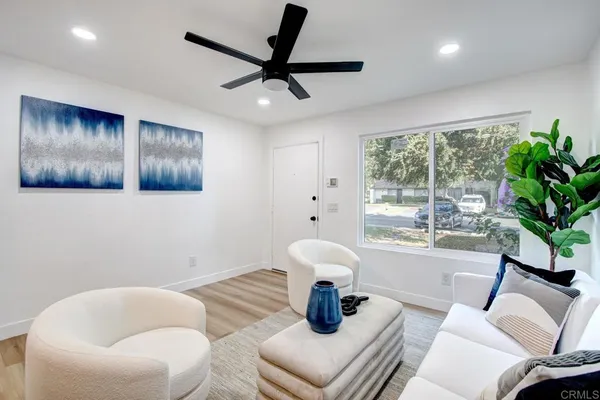 a living room with furniture and a large window