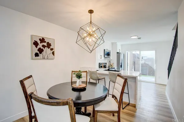 a view of a dining room with furniture wooden floor and a chandelier