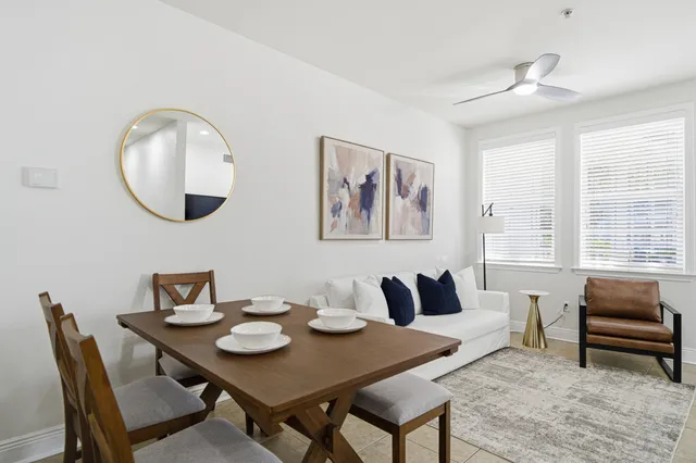 a view of a dining room with furniture and a large window