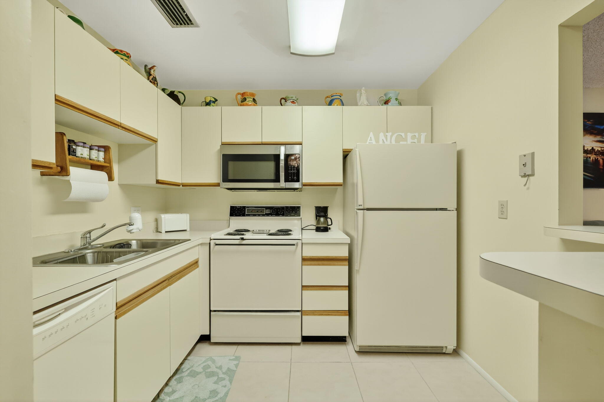 23 Lake Vista Trail, Unit 204 Port St. Lucie, FL 34952 - Photo 11 of 35 a kitchen with a refrigerator a stove a sink and a refrigerator