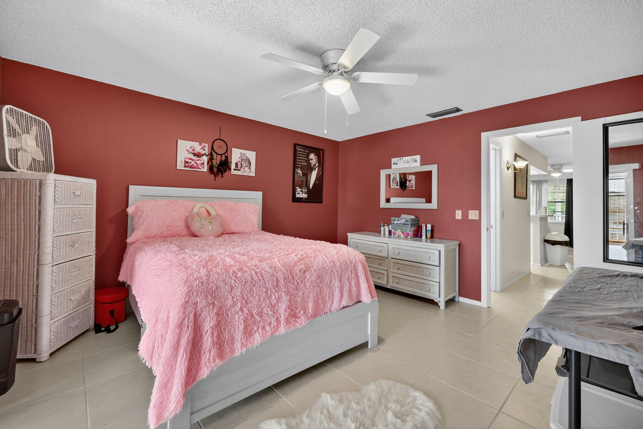 23 Lake Vista Trail, Unit 204 Port St. Lucie, FL 34952 - Photo 15 of 35 a bedroom with a bed and a chandelier