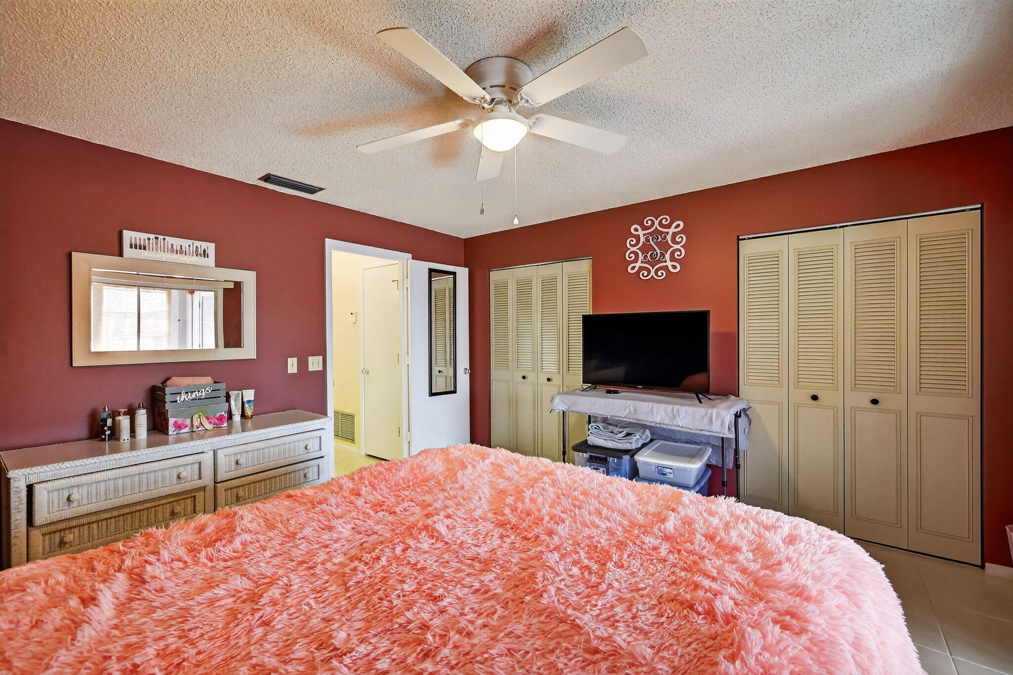 23 Lake Vista Trail, Unit 204 Port St. Lucie, FL 34952 - Photo 17 of 35 a bedroom with a bed and a flat screen tv