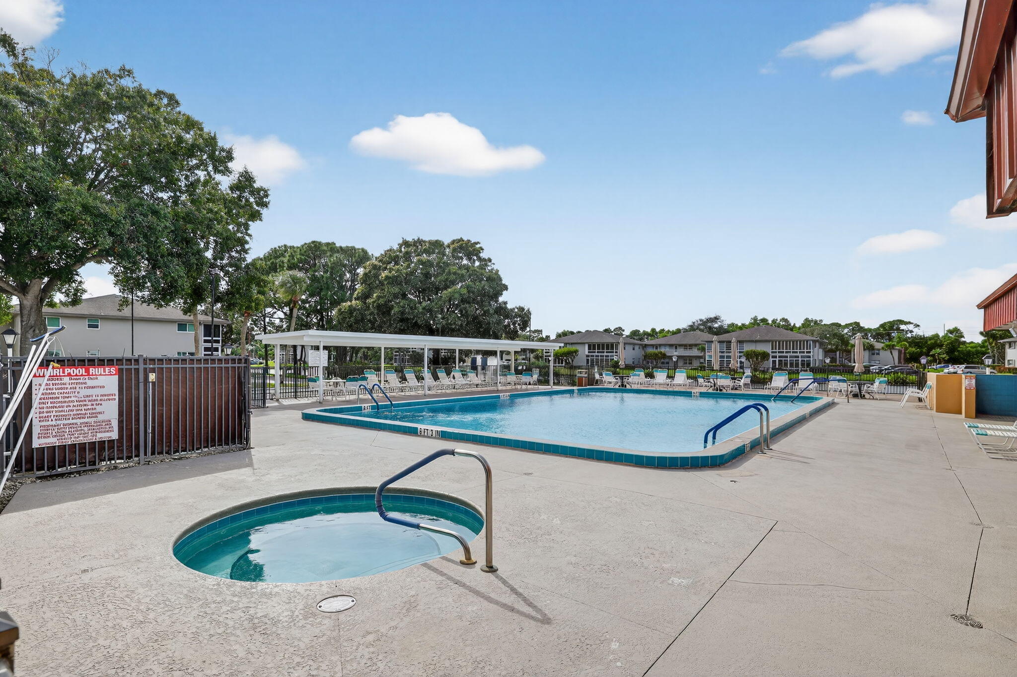 23 Lake Vista Trail, Unit 204 Port St. Lucie, FL 34952 - Photo 25 of 35 a view of a swimming pool with a lounge chair