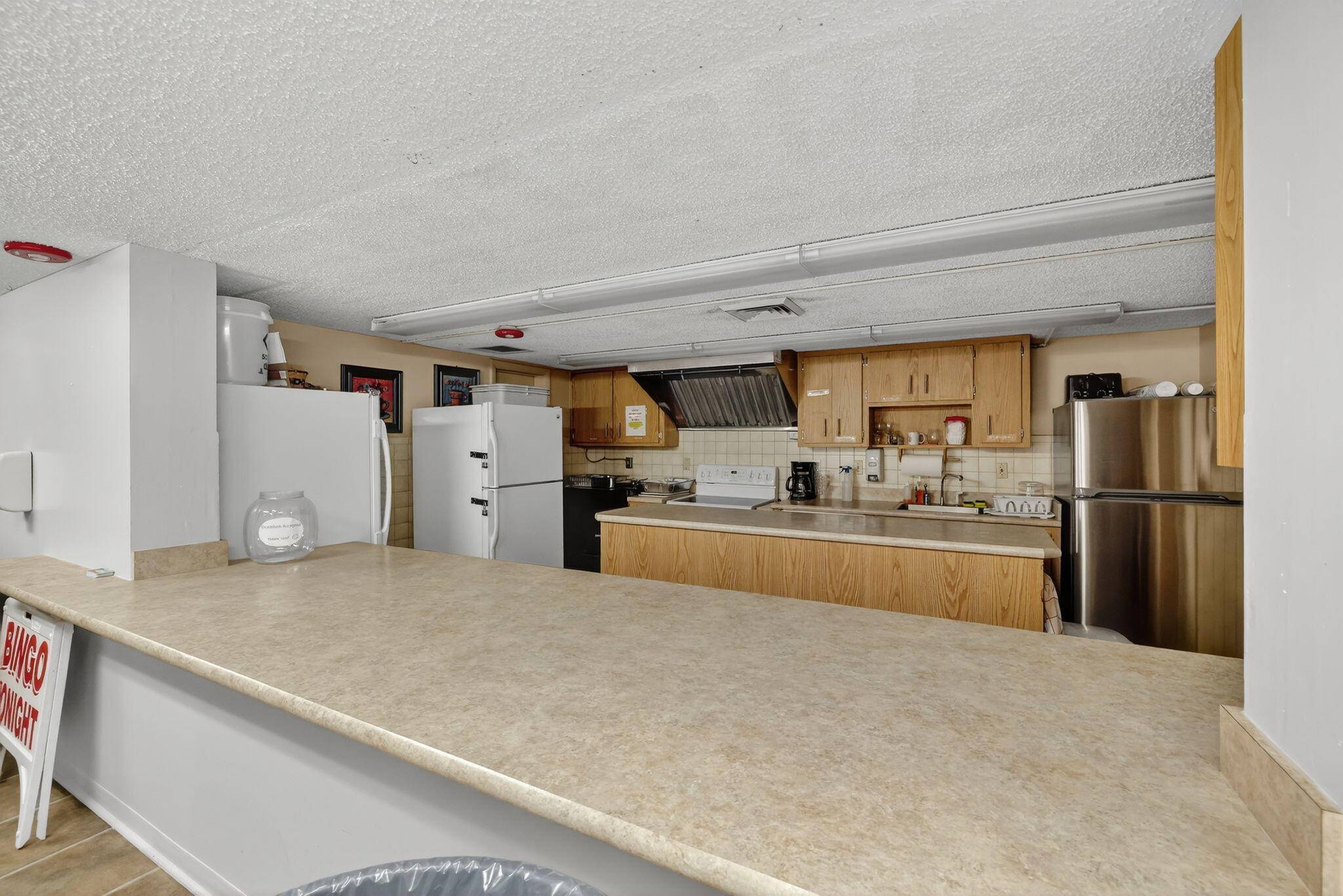 23 Lake Vista Trail, Unit 204 Port St. Lucie, FL 34952 - Photo 28 of 35 a kitchen with stainless steel appliances granite countertop a refrigerator and a stove