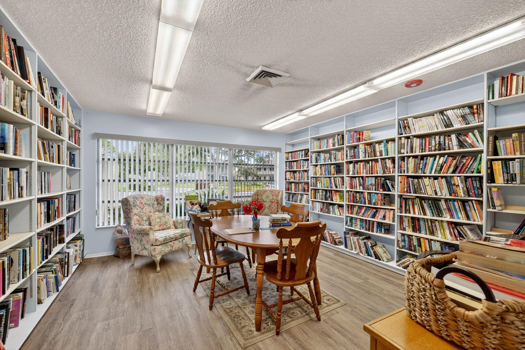 23 Lake Vista Trail, Unit 204 Port St. Lucie, FL 34952 - Photo 30 of 35 a view of a workspace with furniture and a book shelf
