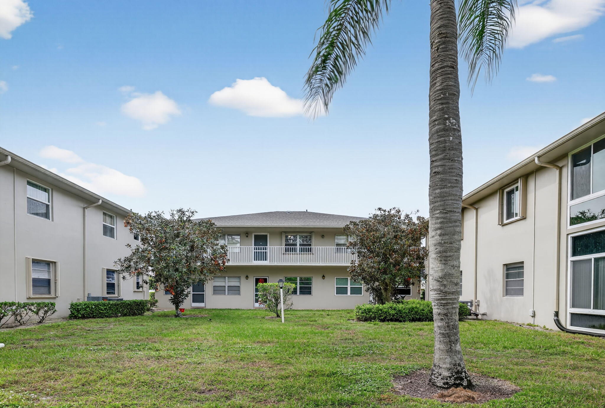 23 Lake Vista Trail, Unit 204 Port St. Lucie, FL 34952 - Photo 4 of 35 a front view of a house with garden