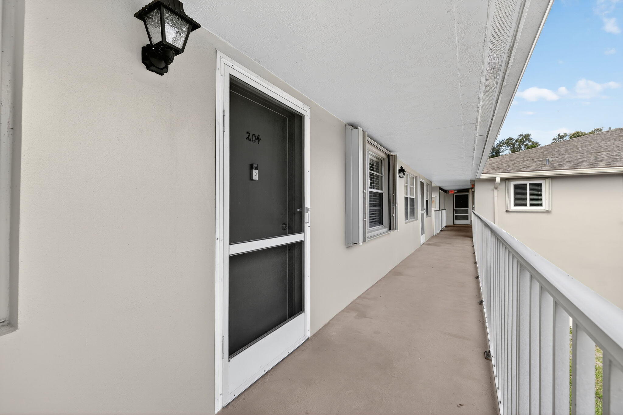 23 Lake Vista Trail, Unit 204 Port St. Lucie, FL 34952 - Photo 7 of 35 a hallway with wooden floor and entryway