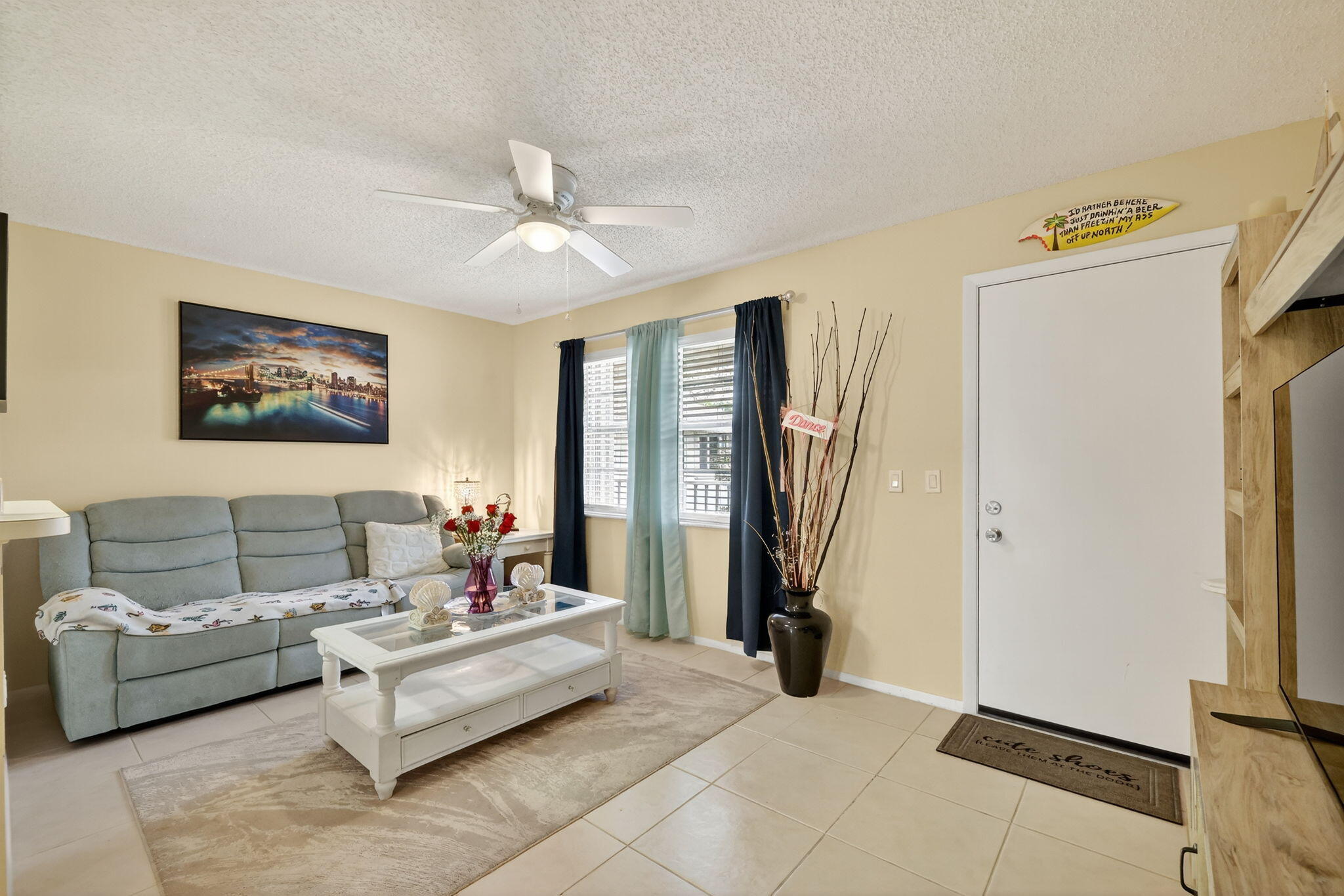 23 Lake Vista Trail, Unit 204 Port St. Lucie, FL 34952 - Photo 9 of 35 a living room with furniture and a flat screen tv