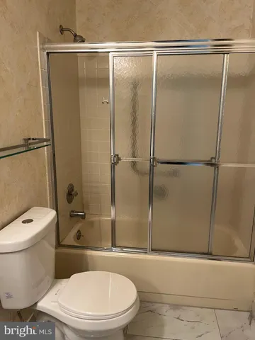 a white toilet sitting next to a bathroom sink