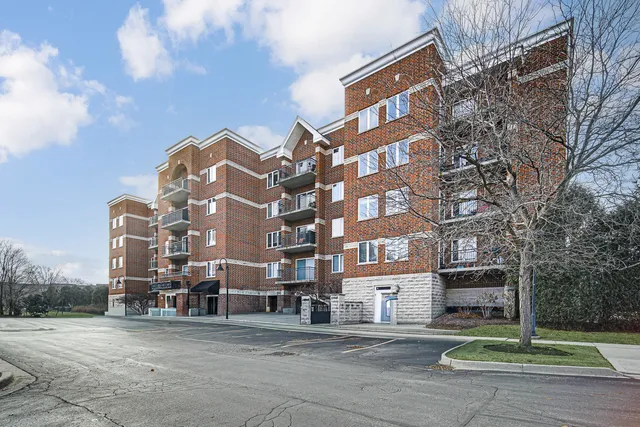 a kitchen with granite countertop a refrigerator stove top oven and sink