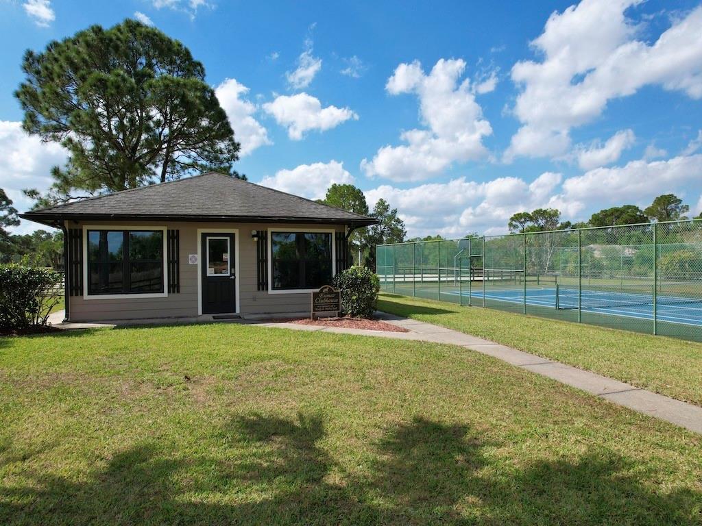 212 Deer Run Road Palm Bay, FL 32909 - Photo 12 of 15 a view of a house with a backyard and porch