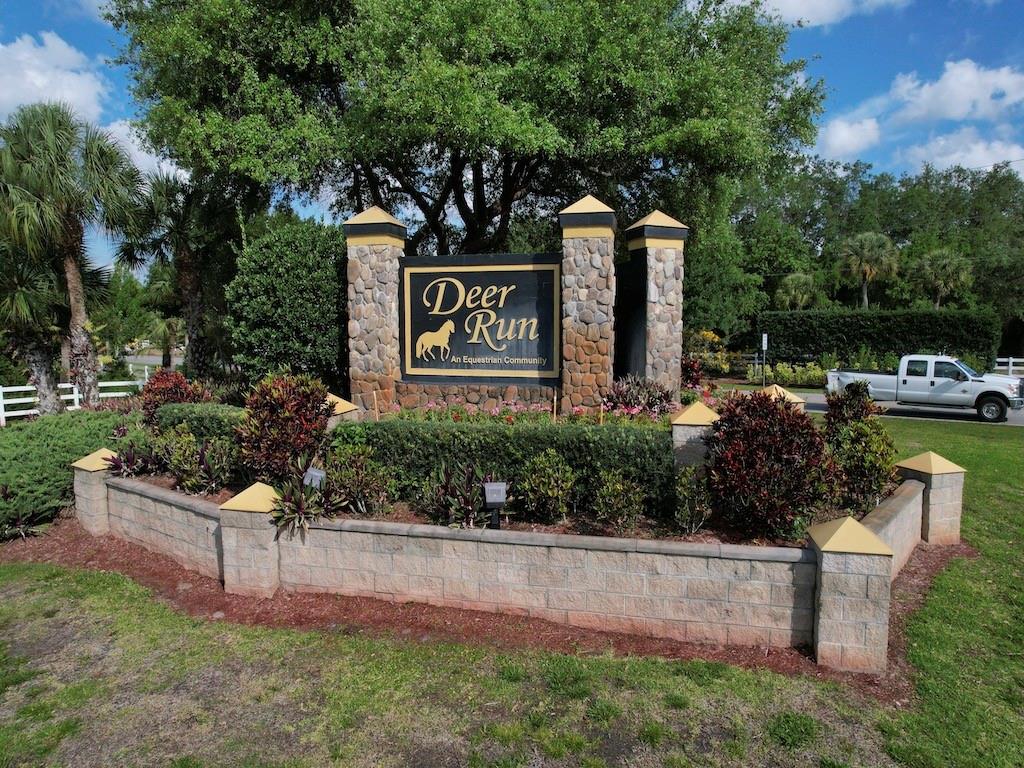 212 Deer Run Road Palm Bay, FL 32909 - Photo 2 of 15 a front view of a house with garden