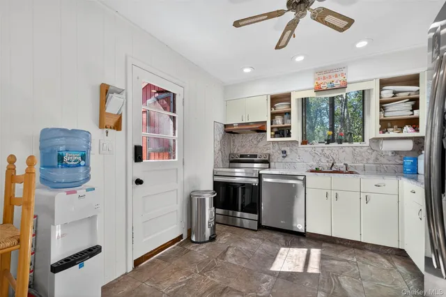 a kitchen with stainless steel appliances granite countertop a stove and a sink