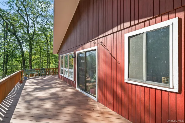 a view of balcony with floor to ceiling window and wooden floor