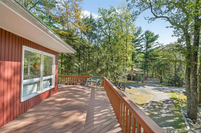 a view of balcony with wooden floor and fence