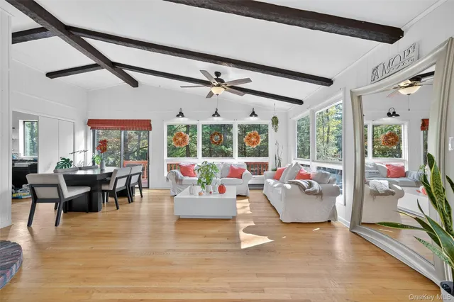 a living room with fireplace furniture and a large window