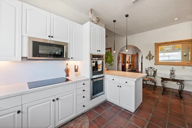 a kitchen with stainless steel appliances a stove and a refrigerator