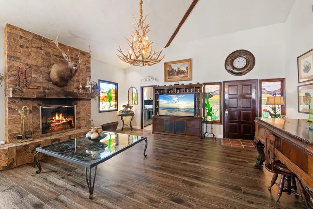 a view of a patio with a table and chairs under an umbrella
