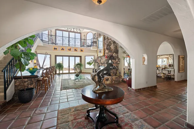 a living room with furniture a fireplace and a potted plant