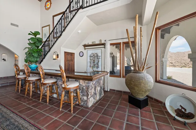 a living room with furniture a chandelier and a fireplace