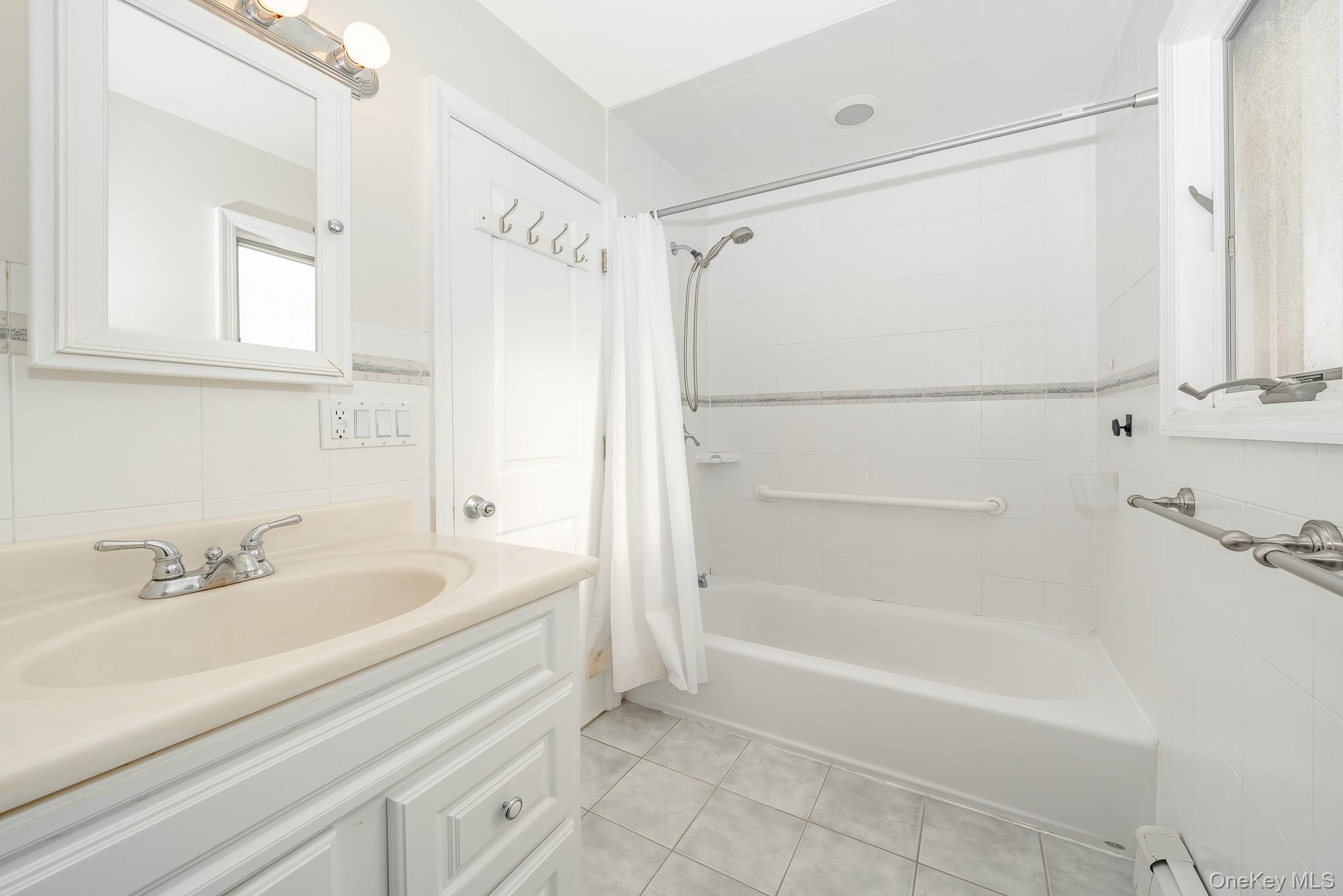 15 Chadwick Road Syosset, NY 11791 - Photo 12 of 35 a bathroom with a bathtub and a shower
