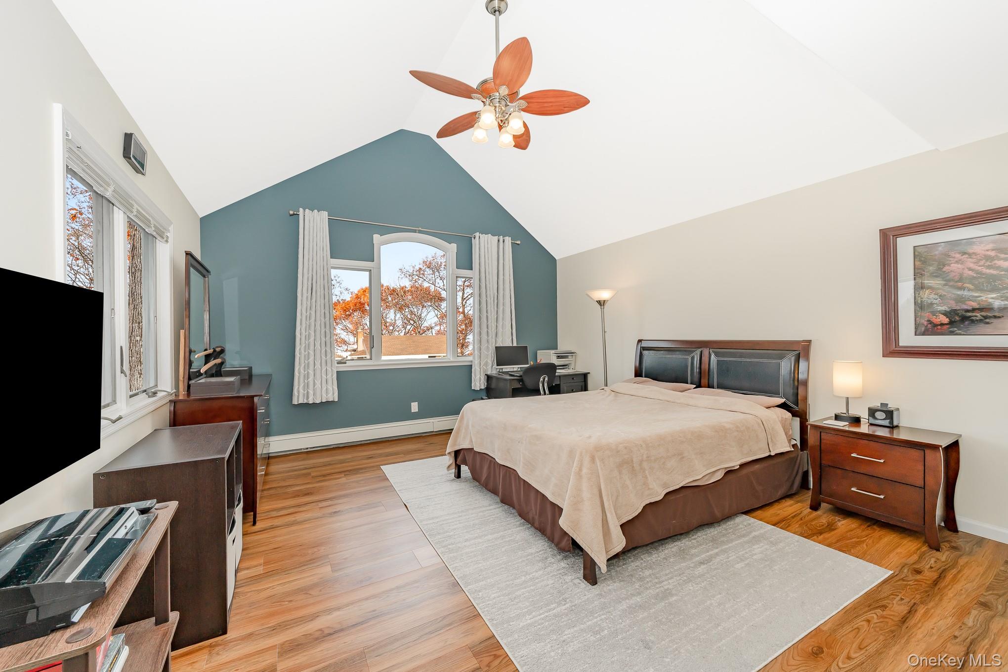 15 Chadwick Road Syosset, NY 11791 - Photo 14 of 35 a bedroom with a bed and a flat screen tv