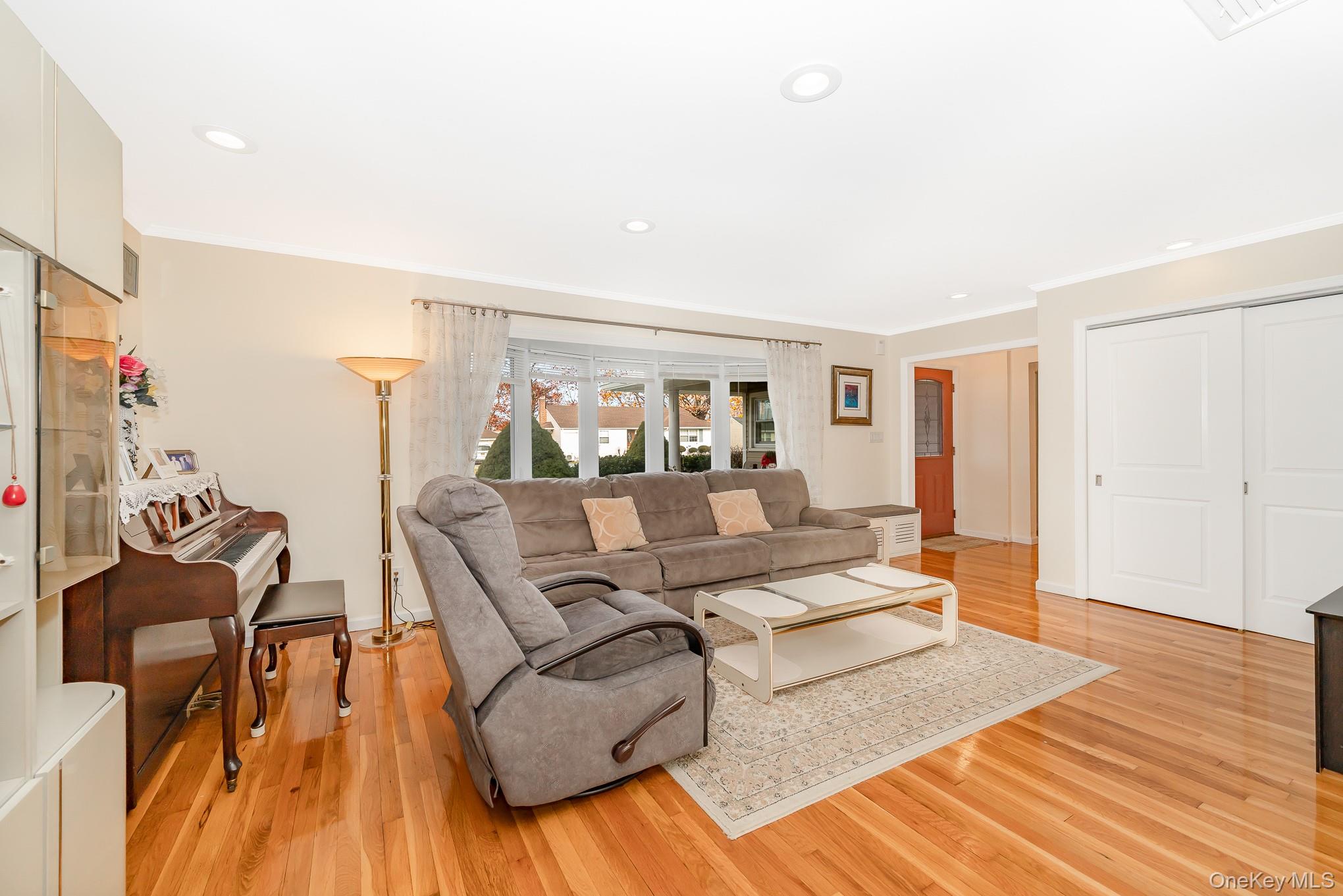 15 Chadwick Road Syosset, NY 11791 - Photo 16 of 35 a living room with furniture and wooden floor