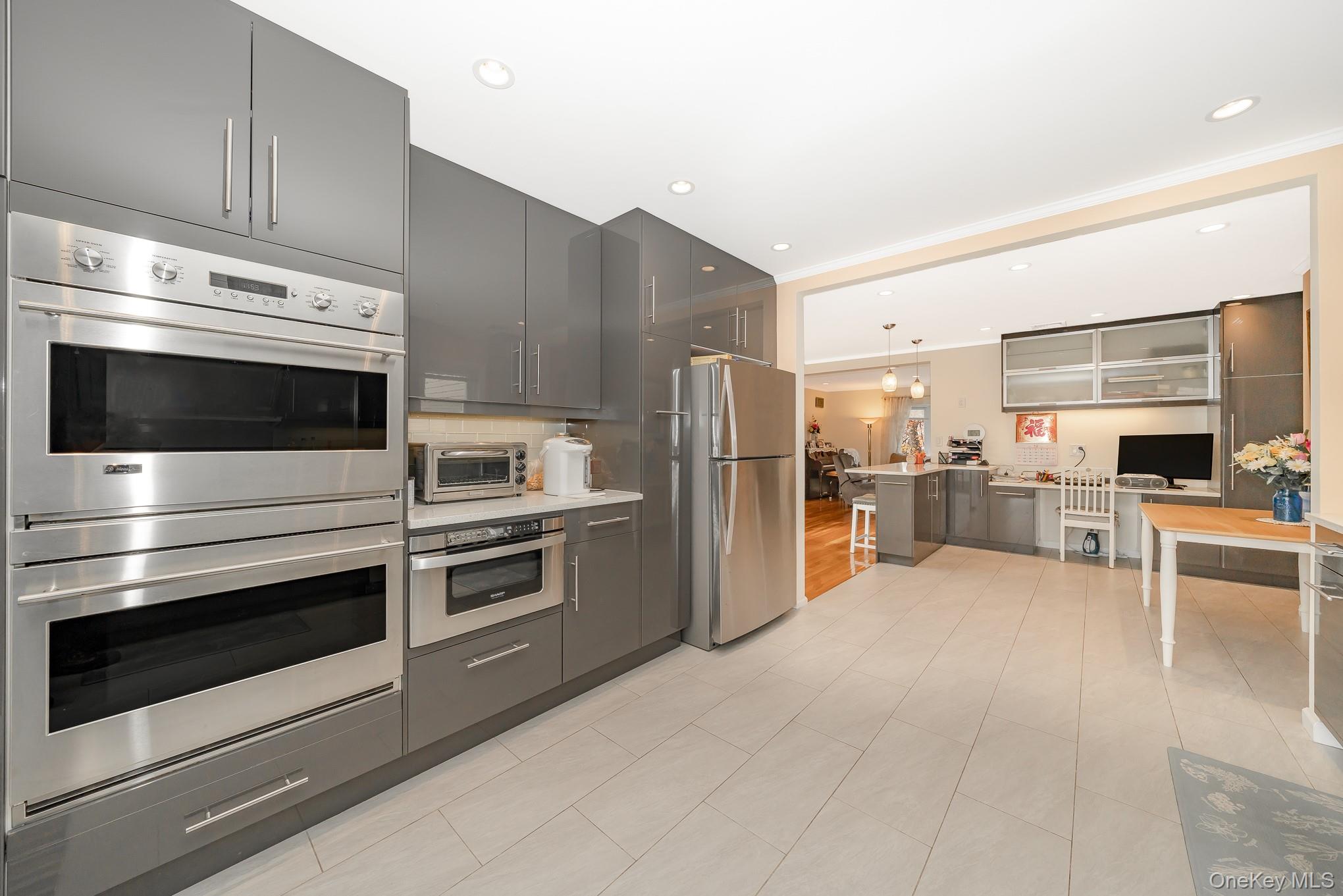 15 Chadwick Road Syosset, NY 11791 - Photo 21 of 35 a kitchen with stainless steel appliances and stove top oven