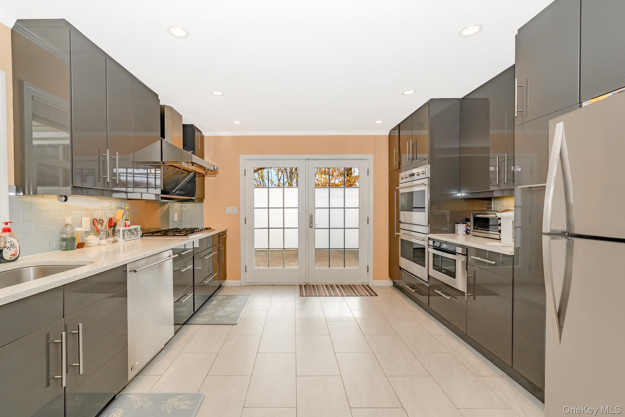 15 Chadwick Road Syosset, NY 11791 - Photo 23 of 35 a kitchen with stainless steel appliances a refrigerator sink and cabinets