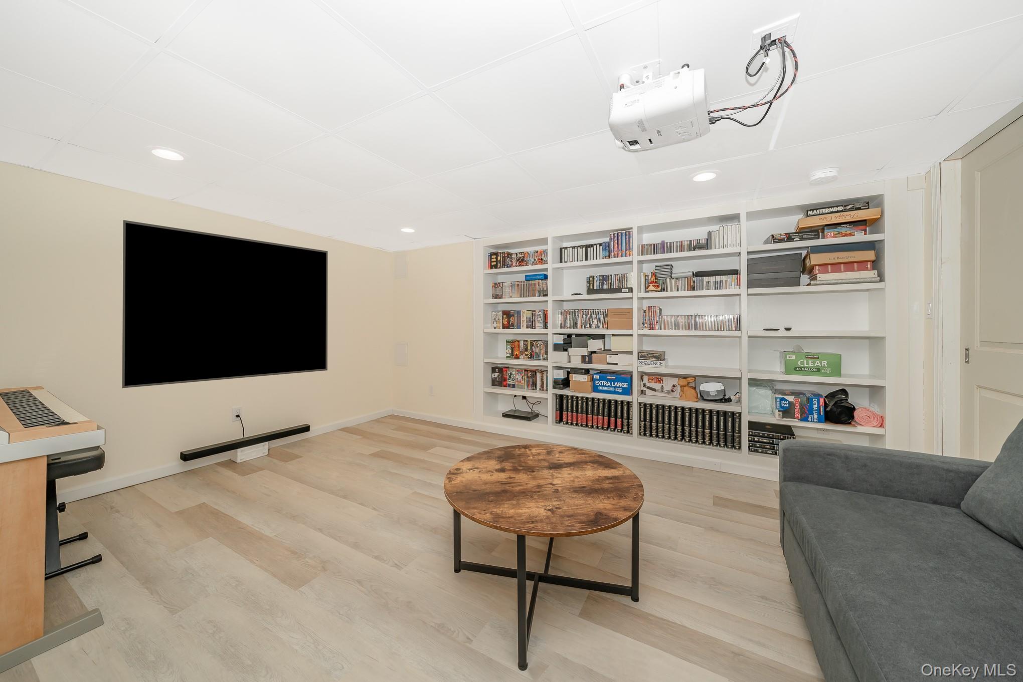 15 Chadwick Road Syosset, NY 11791 - Photo 28 of 35 a living room with furniture and a flat screen tv