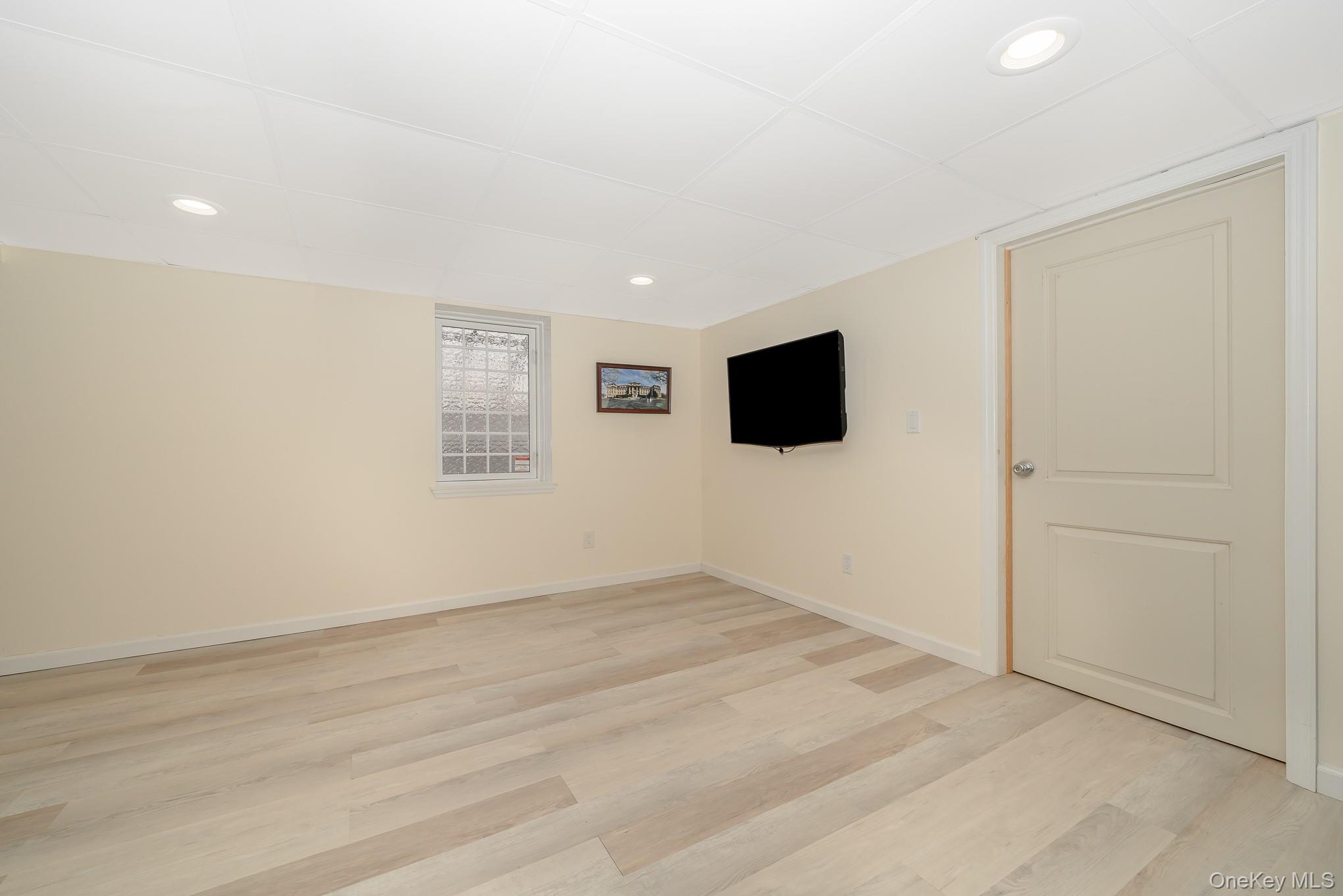 15 Chadwick Road Syosset, NY 11791 - Photo 30 of 35 an empty room with wooden floor and windows