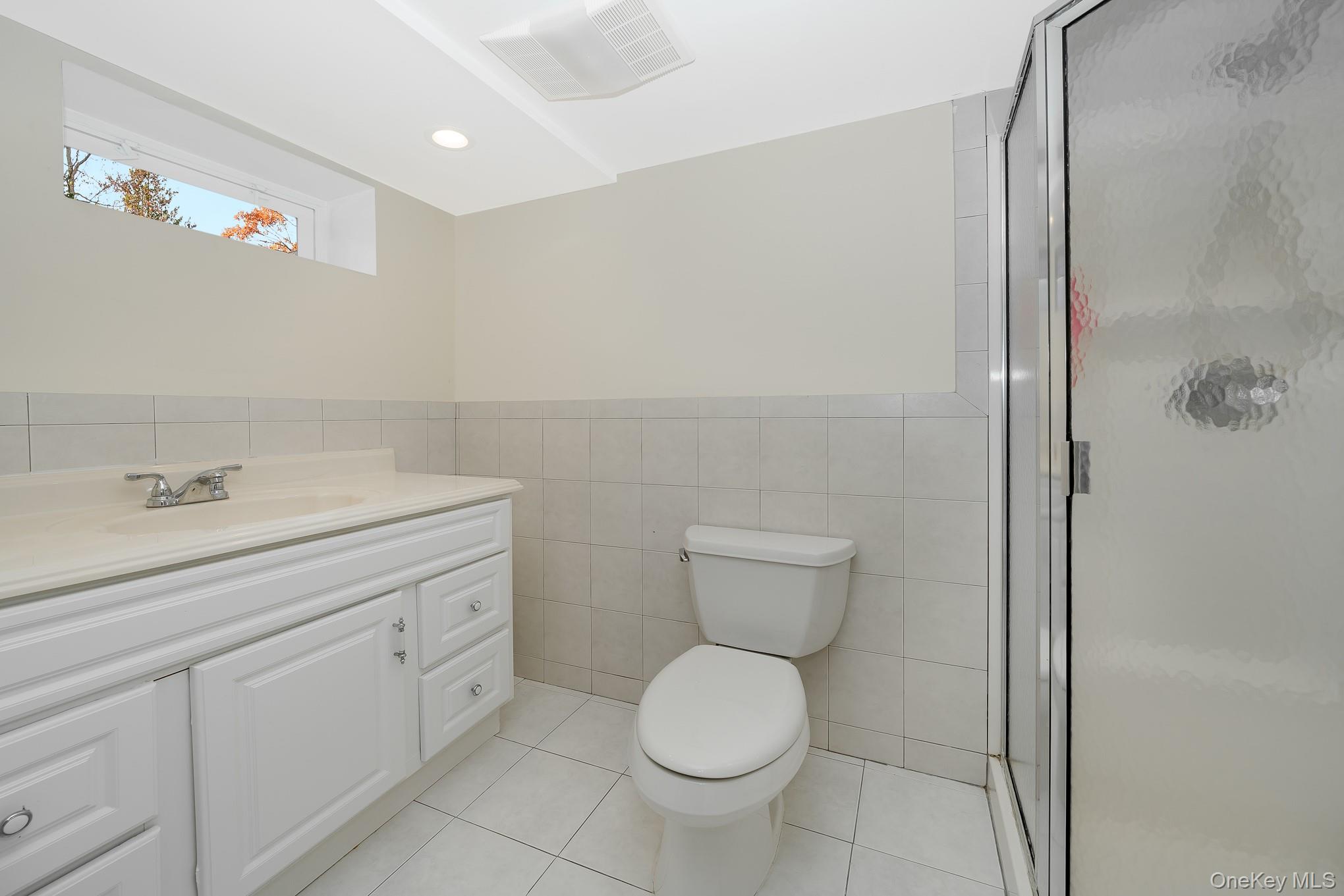 15 Chadwick Road Syosset, NY 11791 - Photo 31 of 35 a bathroom with a toilet sink and mirror