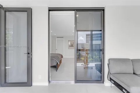 a living room with furniture and a glass door