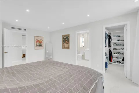 a bedroom with a large bed and a couch