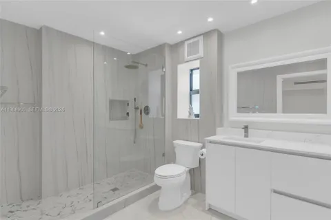 a bathroom with a toilet sink and shower