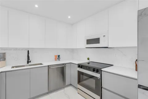 a kitchen with a sink and a stove top oven