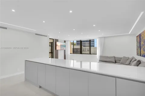 a living room with furniture and kitchen view