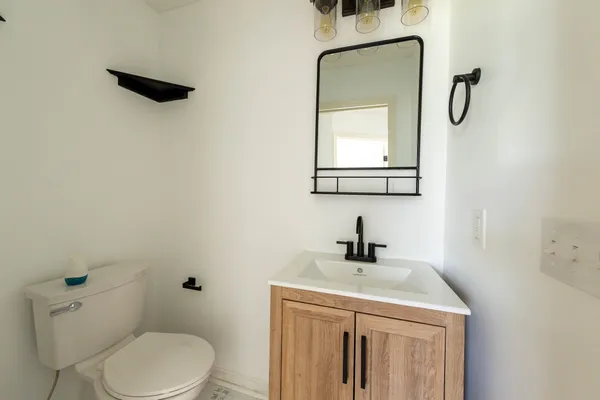 an empty room with a window and a ceiling fan