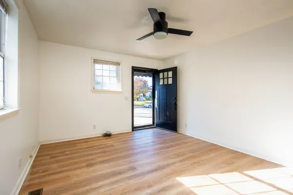 wooden floor in an empty room with a window
