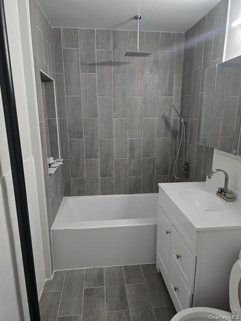 1003 Sacket Avenue Bronx, NY 10462 - Photo 11 of 28 a bathroom with a tub a sink a toilet and a mirror