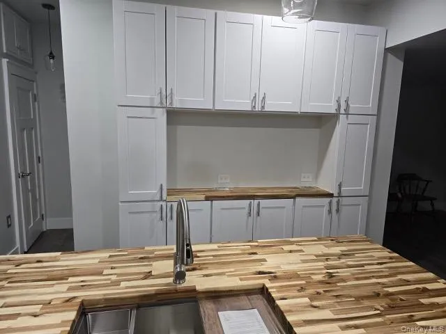 a view of kitchen with refrigerator and microwave